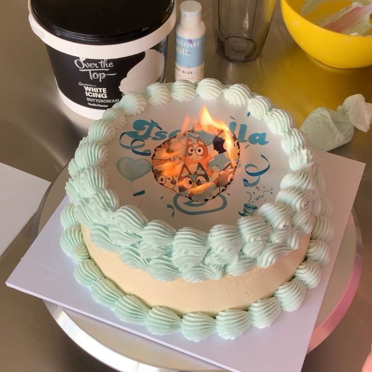 Burn-away cake topper lit to reveal surprise message
